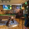 The interior pub games and seating area with TV, dartboard, pool table and electronic pub games at The Hare & Hounds.