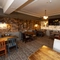Interior dining area of a pub with a TV.