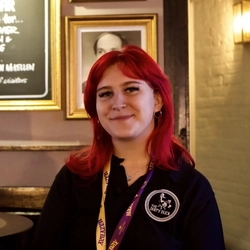 A staff member posing for a picture at the Dirty Duck.