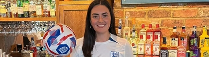 A woman with a football in her hand