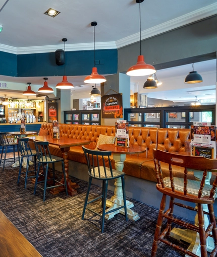 Interior dining area of a pub with a bar.
