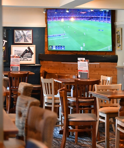 interior of the restaurant and seating area with TV