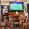 interior of the restaurant and seating area with TV