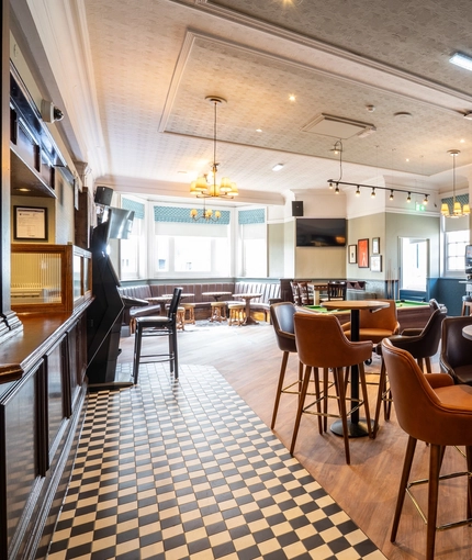 The interior restaurant and seating area with TV at the Black Horse.