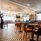 The interior restaurant and seating area with TV at the Black Horse.