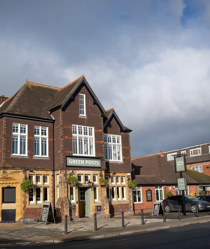 The exterior facade, signage, and car park of the Green Posts in Portsmouth.
