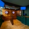 The interior games area at The Globe in Marylebone; with two interactive dartboards on a wood panelled wall.