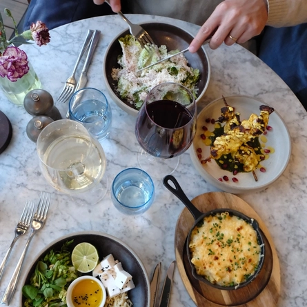 An image showing various dishes within the interior restaurant seating area at The White Horses.