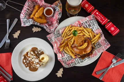 plates of food sitting on a wooden table of a pub