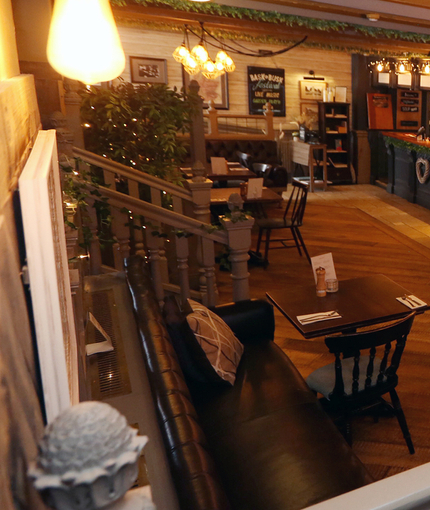 Interior dining area of a pub with a bar.