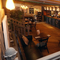 Interior dining area of a pub with a bar.