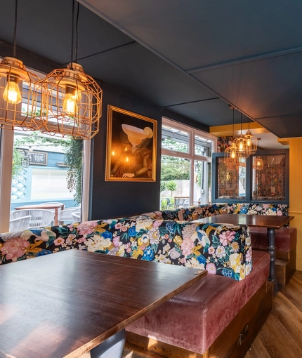 Interior dining area of a pub with a TV.