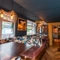 Interior dining area of a pub with a TV.
