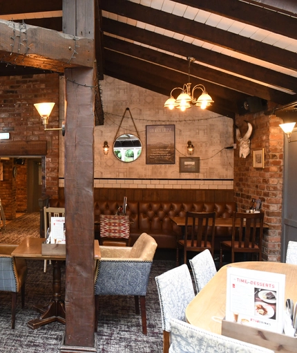 Interior dining area of a pub with a TV.