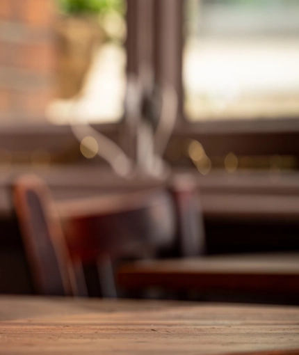 An image focusing on the menus and table decor on one of the tables within the interior restaurant seating area at The Blue Posts.