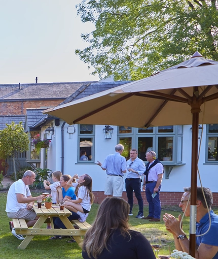 An image of people enjoying the exterior beer garden seating area at The Drum and Monkey.