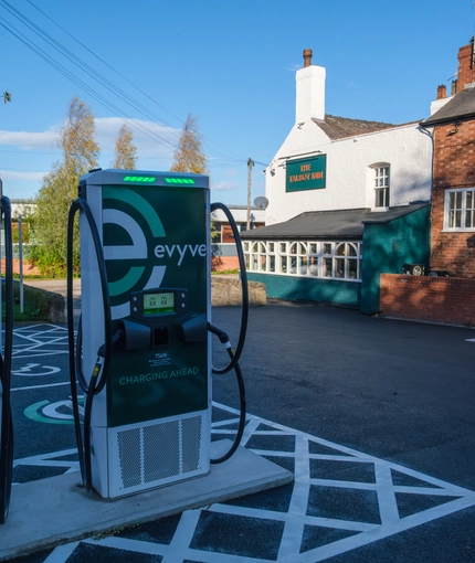 The car park of The Talbot Inn, with electronic vehicle charging points.