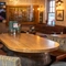 An interior restaurant seating area at The Woolpack Inn; with an upholstered booth seat, and a large TV on the wall.