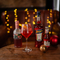 a glass of wine and a few bottles sitting on a wooden table of a pub
