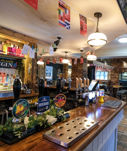 Interior dining area of a pub with a bar.