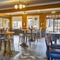 The interior restaurant seating area with pub game dartboards at The Yacht.