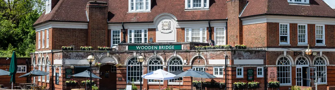 Exterior facade of a pub with a seating area.