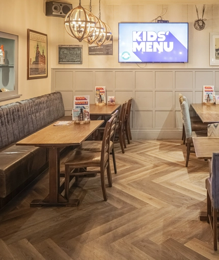 Interior dining area of a pub with a TV.