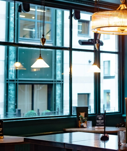 The interior restaurant seating area with TV screen at The Three Crowns.