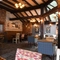 Interior conservatory of a pub with a dining area and a TV.