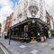 External view of a pub entrance and outdoor seating area