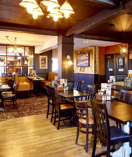 The interior restaurant seating area with TV, at The Good Intent in Hornchurch.
