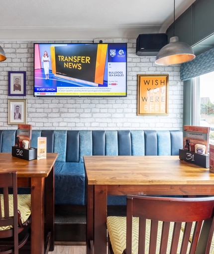 An interior shot of the restaurant, sport and seating area at the Waterside in Shoreham-By-Sea.