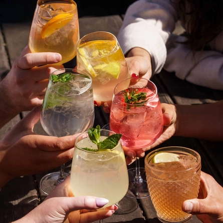 An exterior shot of people enjoying summer drinks in the beer garden at Urban Core & Heritage venues.