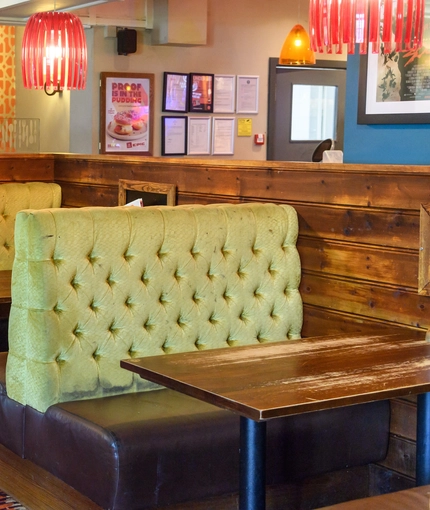 Interior dining area of a pub with a TV.