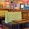 Interior dining area of a pub with a TV.