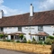 The exterior facade with seating area at the Crown Inn.