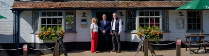A Pub Partners image showing 3 people stood outside the Shinfield Arms.