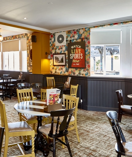 The interior restaurant seating area with TV, at The Fox and Crown in Sutton-in-Ashfield.