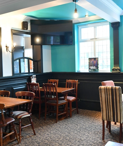 interior dining area of a pub with a TV