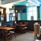 interior dining area of a pub with a TV