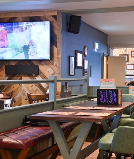 Interior seating area / restaurant with a TV on the wall