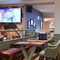 Interior seating area / restaurant with a TV on the wall