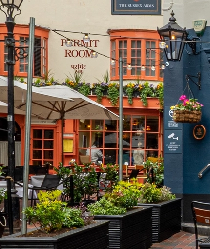 The exterior facade and beer garden seating area of The Sussex Arms.