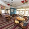 Interior dining area of a pub with a TV.