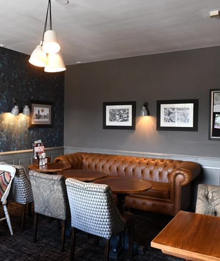Interior dining area of a pub with a TV.