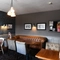 Interior dining area of a pub with a TV.
