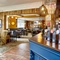The bar and interior restaurant seating area with TV at the Fox and Crown.