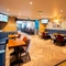 The interior seating area with two TVs on the wall at the Armstrongs.