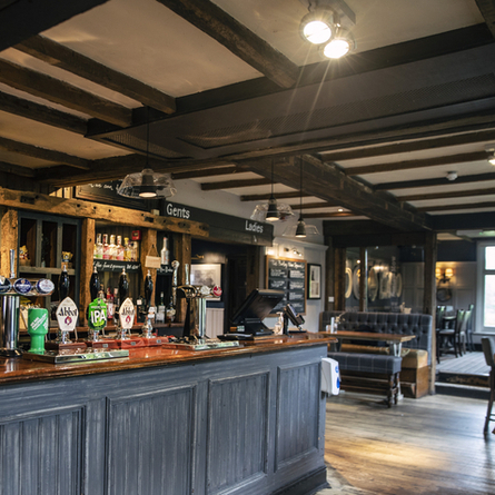 The bar and seating areas of The Barley Mow.