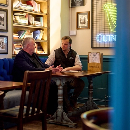A Pub Partners image showing 2 people sat at a table at the Hertford Bell.